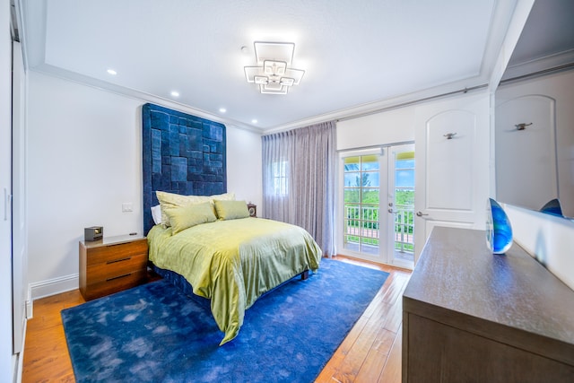 bedroom featuring french doors, hardwood / wood-style flooring, access to exterior, and crown molding