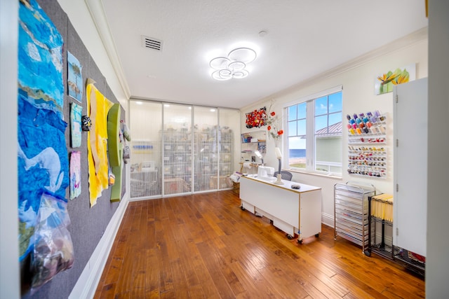 office area with a textured ceiling, hardwood / wood-style floors, and crown molding