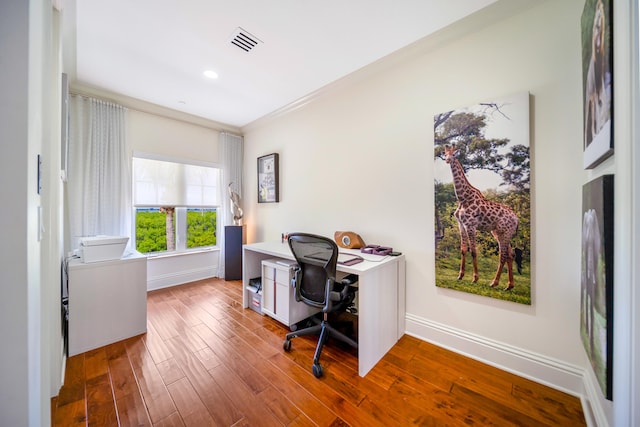 home office featuring hardwood / wood-style flooring and crown molding