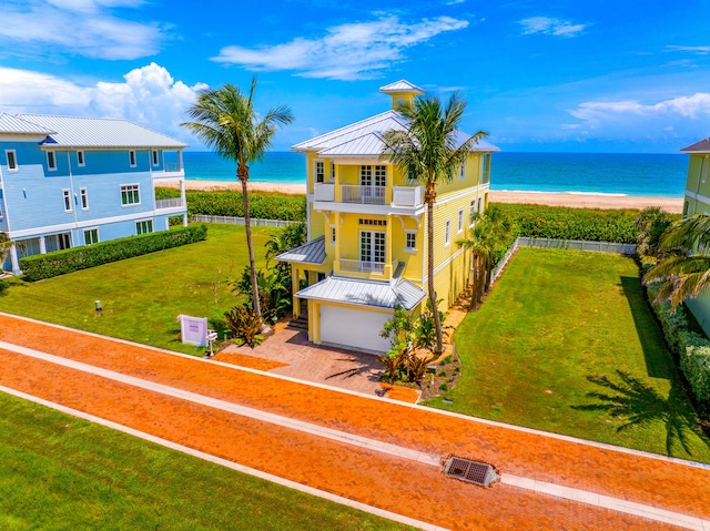 drone / aerial view with a water view and a beach view