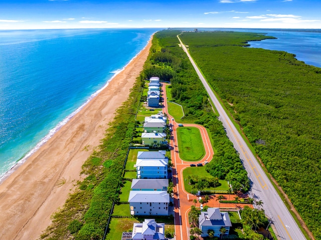 birds eye view of property with a beach view and a water view