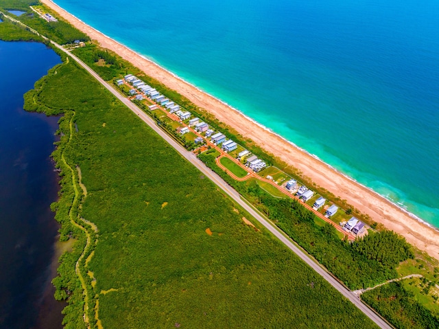 birds eye view of property featuring a view of the beach and a water view