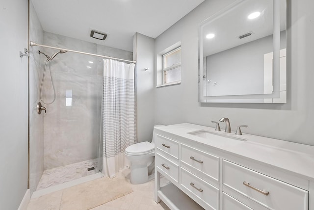 bathroom featuring tile patterned flooring, vanity, toilet, and walk in shower