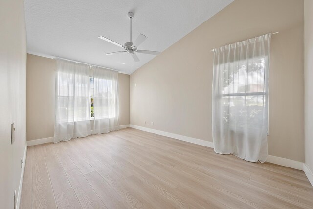 381 NW Sherry Ln, Port Saint Lucie, FL 34986 - empty room with a ceiling fan, light wood-style floors, lofted ceiling, and baseboards