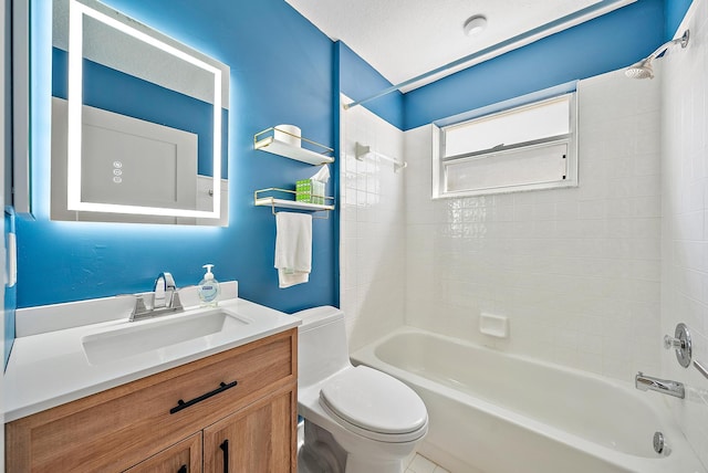 full bathroom with tiled shower / bath, vanity, a textured ceiling, and toilet