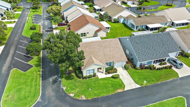 single story home featuring a garage and a yard