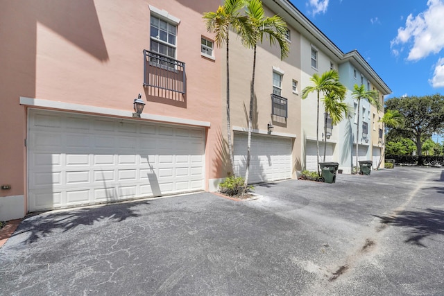 view of property featuring aphalt driveway and an attached garage