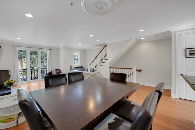 dining space featuring baseboards, light wood finished floors, stairway, and recessed lighting