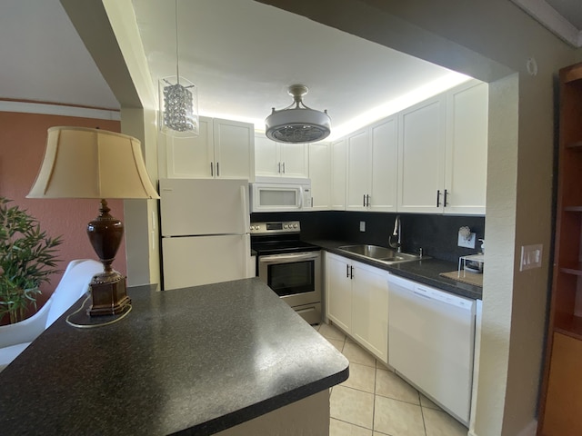 kitchen with white cabinetry, sink, light tile patterned flooring, and white appliances