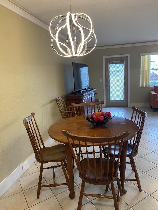 dining space with an inviting chandelier, light tile patterned floors, and ornamental molding