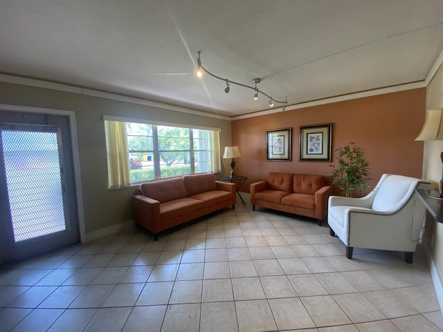 tiled living room featuring crown molding and track lighting