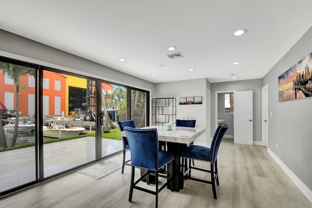 dining space featuring light wood-type flooring, visible vents, baseboards, and recessed lighting