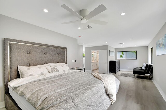 bedroom with ceiling fan, wood-type flooring, and ensuite bathroom