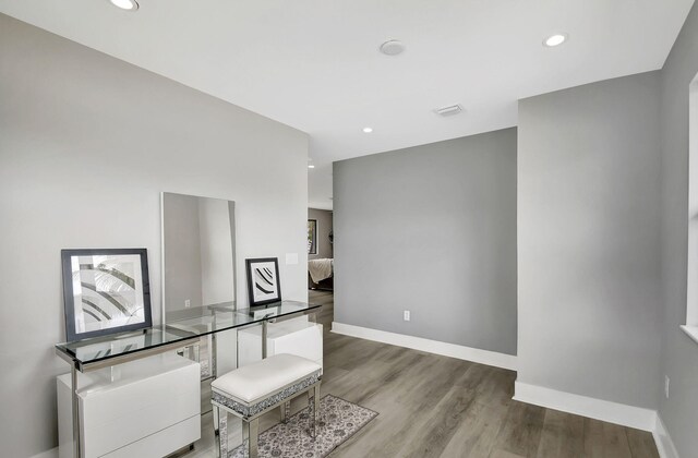 office space featuring baseboards, recessed lighting, visible vents, and light wood-style floors