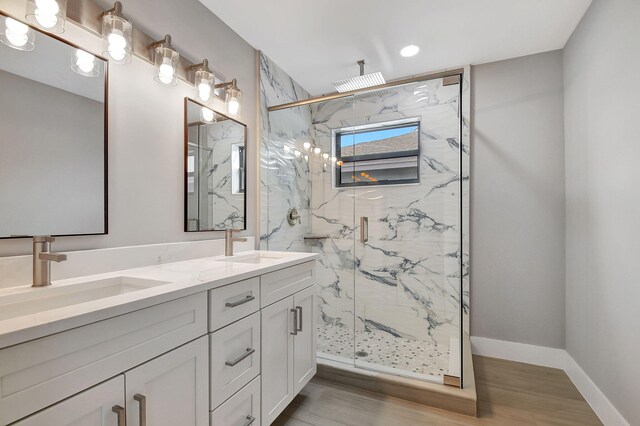 bathroom featuring wood-type flooring, a shower with door, and vanity