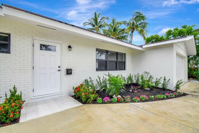 view of exterior entry with a garage