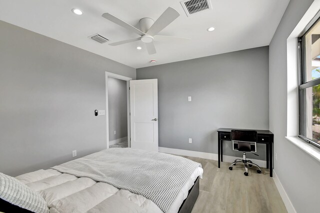 bedroom with ceiling fan and light wood-type flooring