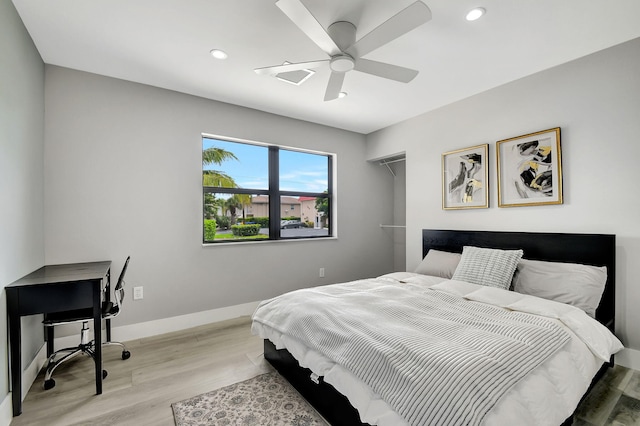 bedroom with a ceiling fan, recessed lighting, light wood-style flooring, and baseboards