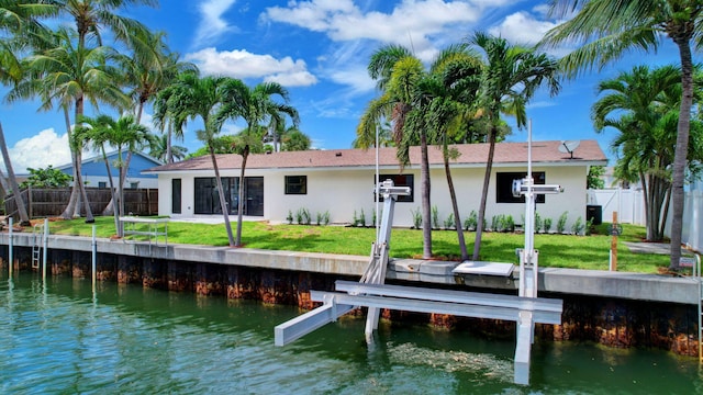 view of dock featuring a lawn and a water view