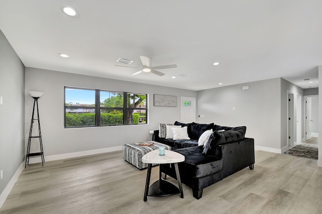 living room with light wood-type flooring and ceiling fan