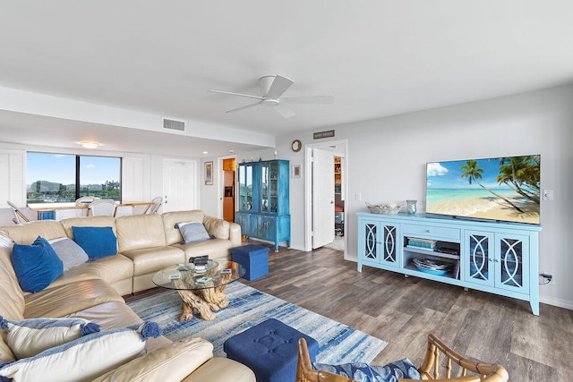 living room featuring ceiling fan and hardwood / wood-style flooring