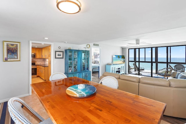 dining area with ceiling fan and light hardwood / wood-style floors