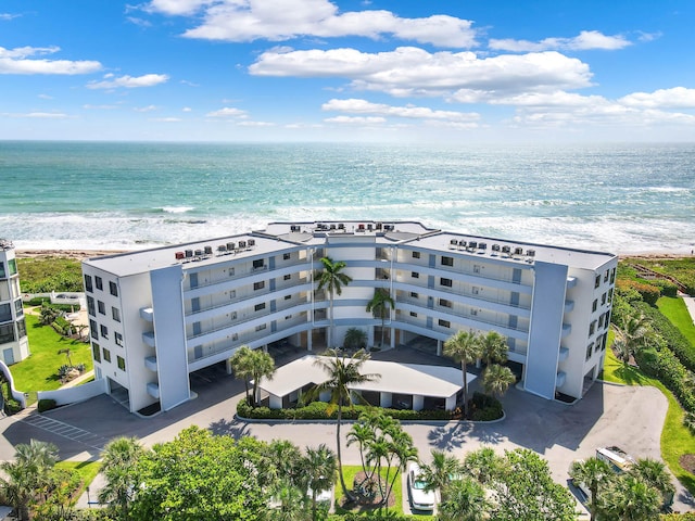 bird's eye view featuring a water view and a beach view