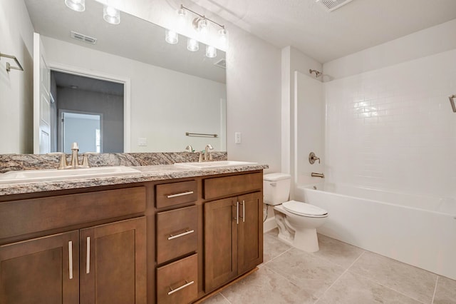 full bathroom featuring tile patterned flooring, vanity, toilet, and tiled shower / bath combo