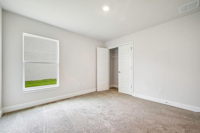 unfurnished bedroom with a closet and carpet floors