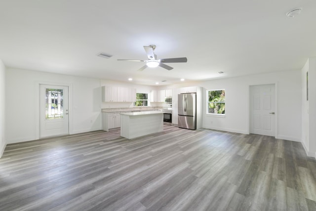 unfurnished living room featuring light hardwood / wood-style flooring and ceiling fan