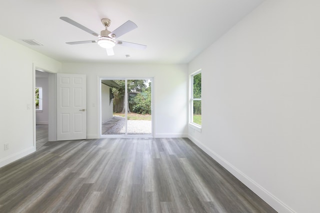 spare room with dark hardwood / wood-style flooring and ceiling fan