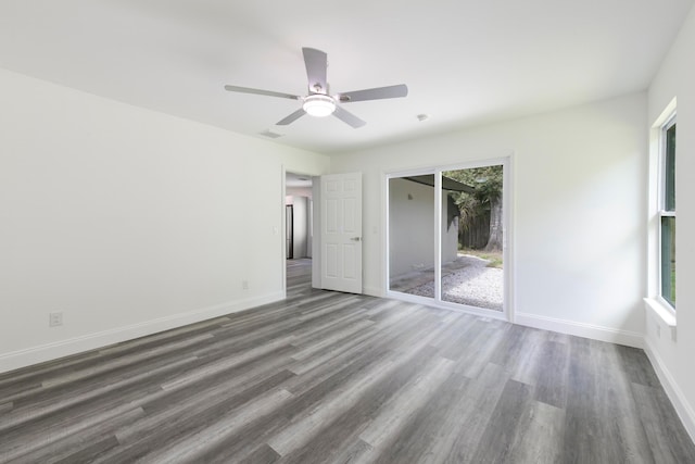 unfurnished bedroom featuring ceiling fan, dark hardwood / wood-style floors, and access to exterior