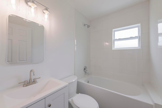 full bathroom with tiled shower / bath, toilet, and vanity