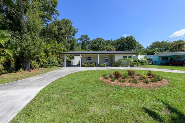 view of front facade with a carport and a front yard