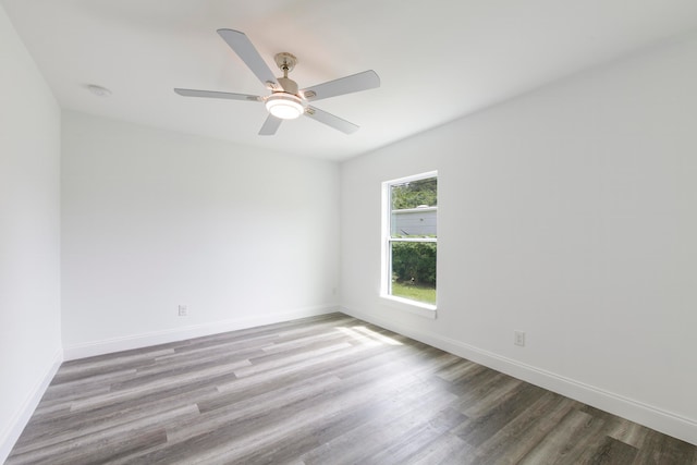 empty room with ceiling fan and wood-type flooring