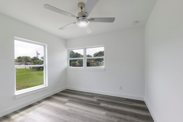 unfurnished room with a healthy amount of sunlight, wood-type flooring, and ceiling fan