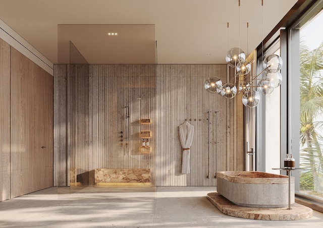 bathroom with concrete floors, wooden walls, and a chandelier