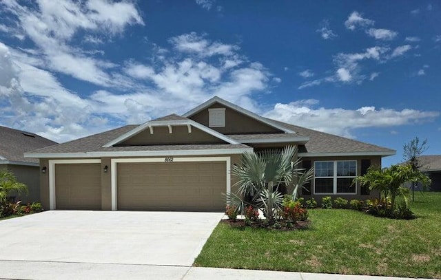 view of front of house featuring a front yard and a garage