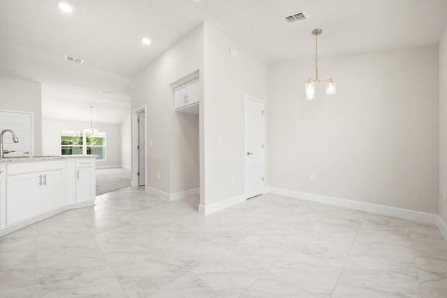 interior space featuring a chandelier and sink