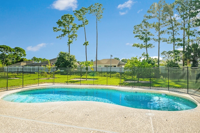 view of pool with a lawn