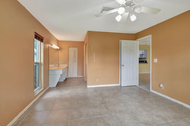 5020 Petal Pl Unit D, Delray Beach, FL 33484 - unfurnished bedroom featuring light tile patterned flooring and a ceiling fan