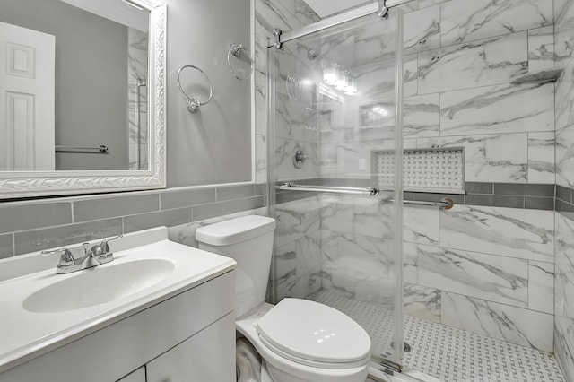 bathroom featuring tasteful backsplash, tile walls, vanity, an enclosed shower, and toilet