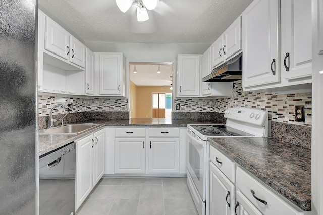 5020 Petal Pl Unit D, Delray Beach, FL 33484 - kitchen featuring white range with electric cooktop, stainless steel dishwasher, under cabinet range hood, dark countertops, and light tile patterned floors