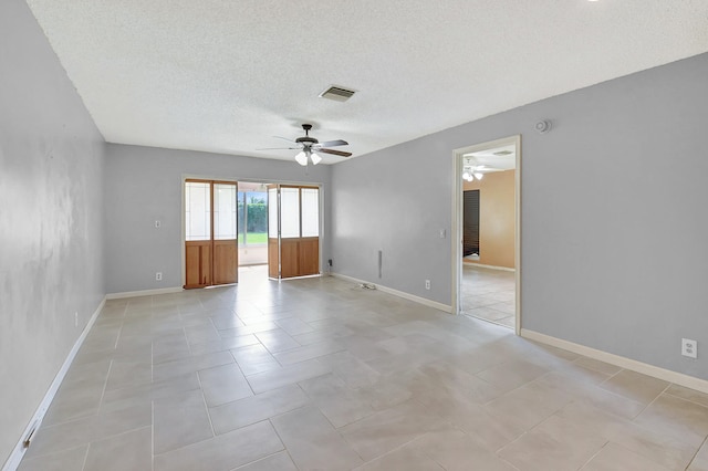 unfurnished room with ceiling fan, a textured ceiling, and light tile patterned flooring