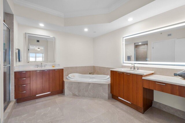 bathroom featuring ornamental molding, vanity, and shower with separate bathtub