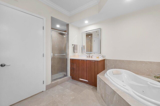 bathroom featuring ornamental molding, shower with separate bathtub, and vanity