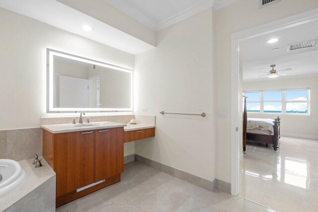 bathroom with ornamental molding, tiled bath, vanity, and ceiling fan