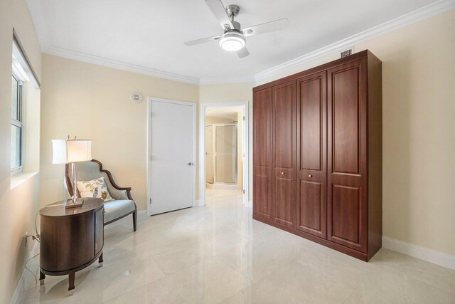 sitting room featuring crown molding and ceiling fan