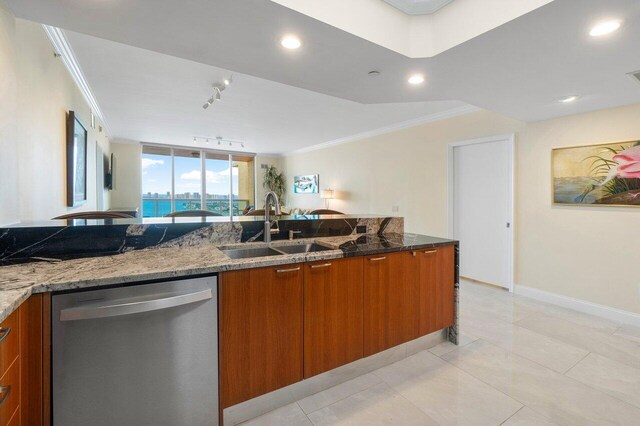 kitchen with dark stone countertops, sink, crown molding, and dishwasher