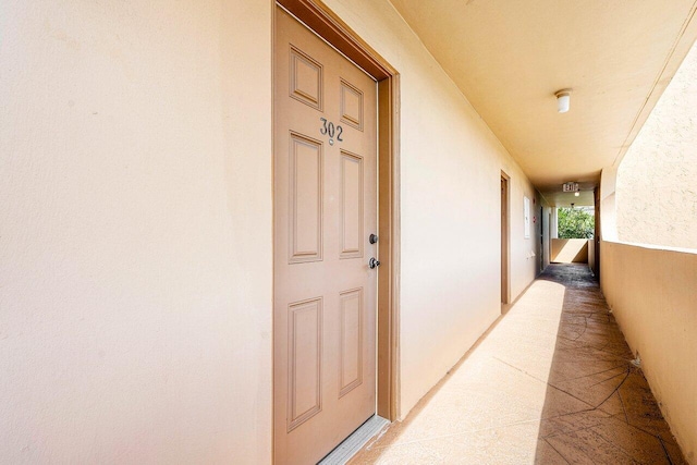 doorway to property featuring stucco siding